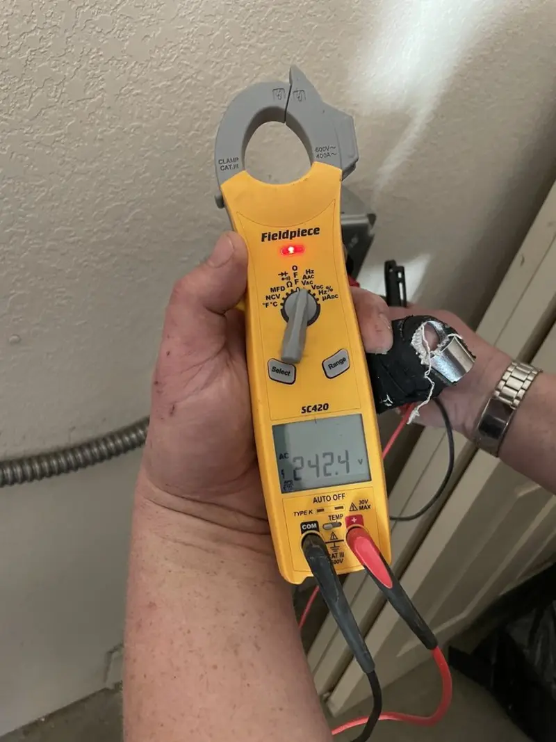 Voltage testing with clamp meter during Ceiling Fan Installation in San Juan
